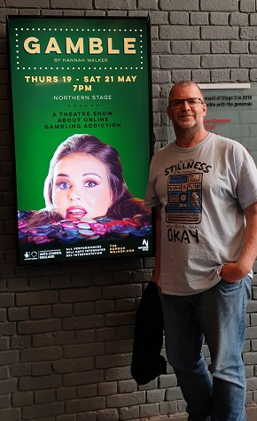 Jon Bryan next to Gamble poster